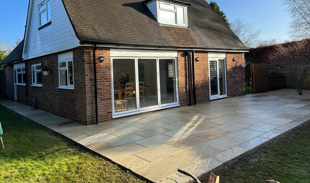 Indian sandstone patio laid across the rear of a Berkshire house